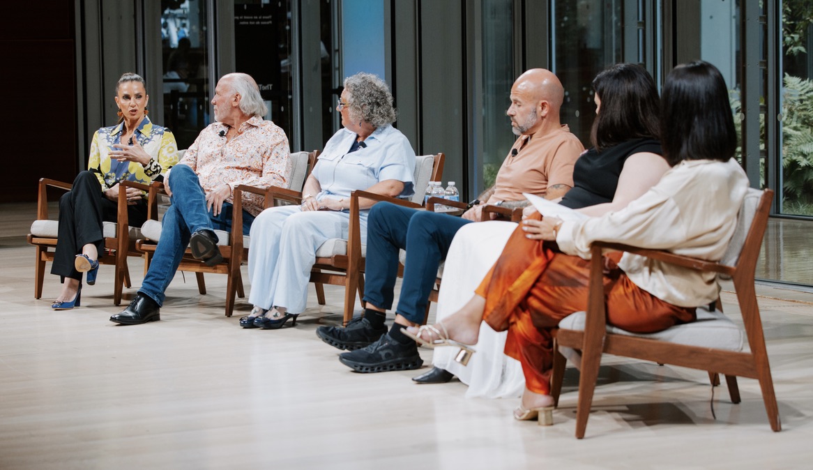 MaryAnne Karstadt on stage with fellow panelists in front of a live audience
