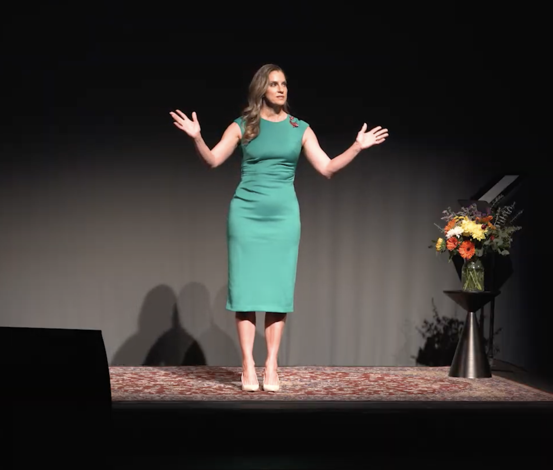 MaryAnne Karstadt full length on stage with arms open at the Tempe Center for the Arts