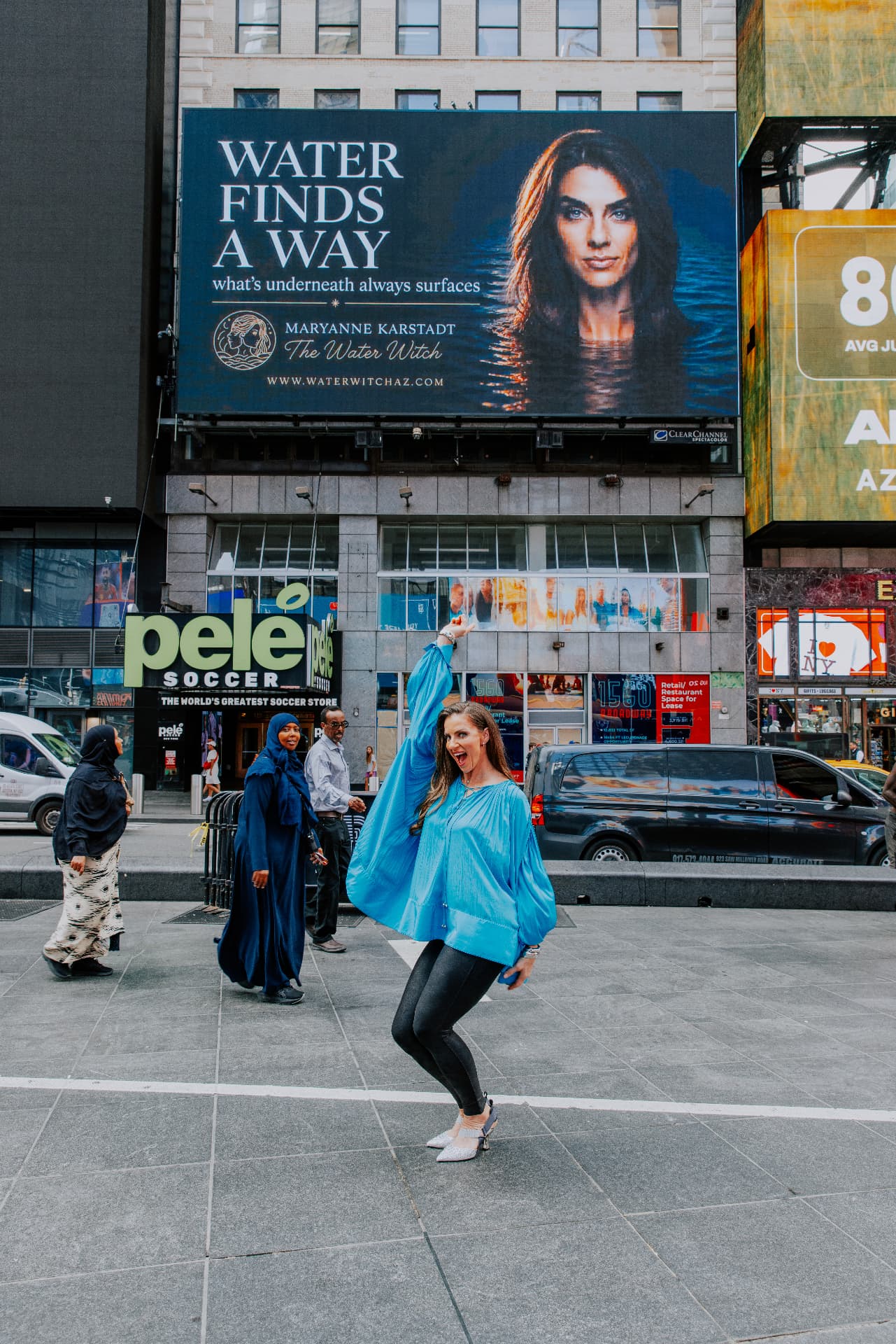 MaryAnne Karstadt in Times Square in front of the Water Finds a Way billboard